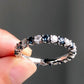 1.40 Ct Brilliant Round Moissanite With Blue Sapphires Eternity Band