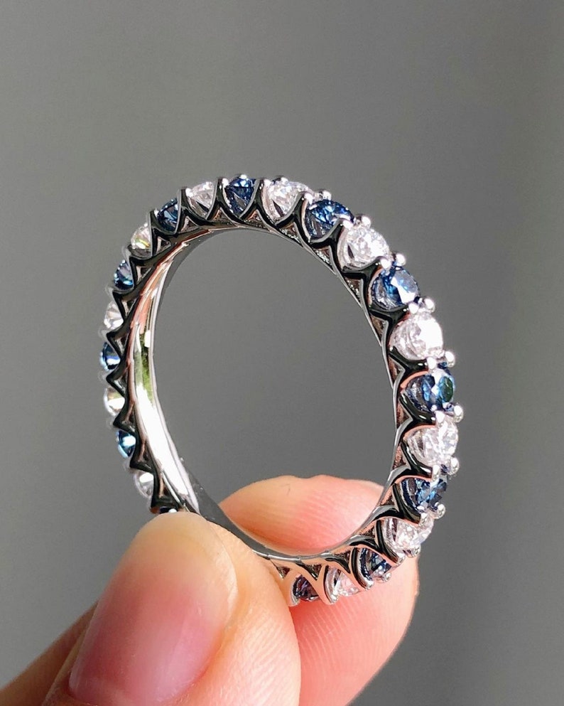 1.40 Ct Brilliant Round Moissanite With Blue Sapphires Eternity Band